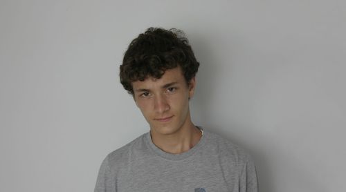 Portrait of young man against white background