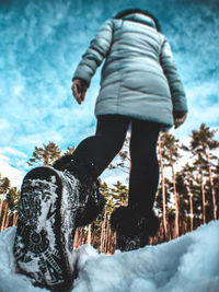 Rear view of woman on snow covered field