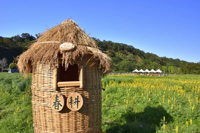 Traditional windmill on field against clear sky