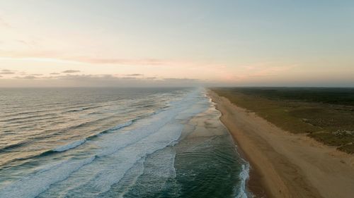 Scenic view of beach against sky during sunset