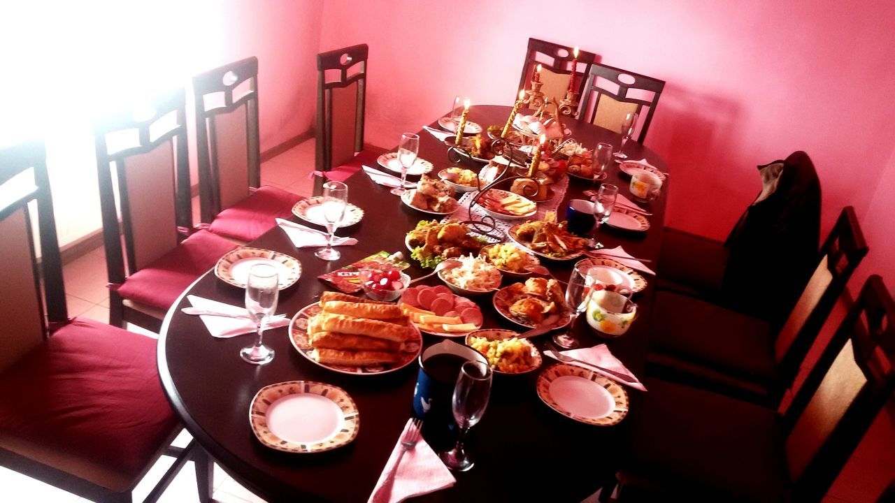 indoors, still life, table, no people, food and drink, low angle view, home interior, red, food, decoration, close-up, hanging, large group of objects, day, wood - material, built structure, freshness, high angle view, plate, variation