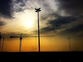 Low angle view of street light against sky at sunset