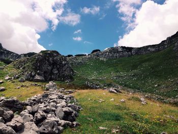 Scenic view of mountains against cloudy sky