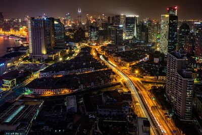 High angle view of illuminated city buildings at night