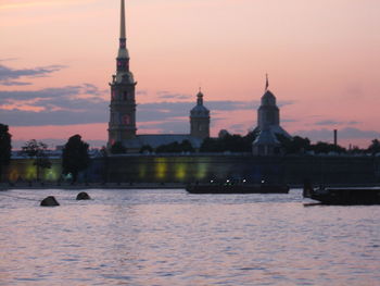 View of river and buildings at sunset