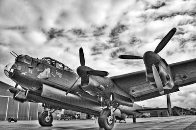 Low angle view of airplane at airport runway against sky