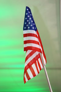 Close-up of american flag against illuminated wall