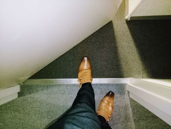 Low section of man standing on staircase