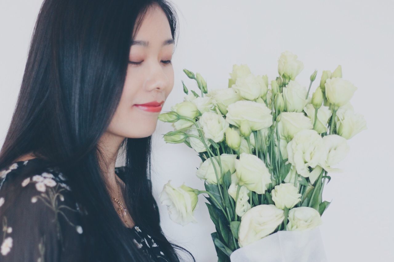 YOUNG WOMAN HOLDING FLOWER