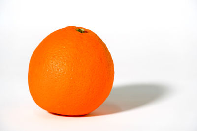 Close-up of orange slice against white background