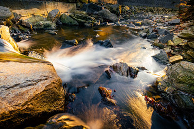 High angle view of stream flowing through rocks