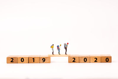 Group of people with toy against white background