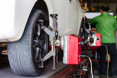 Equipment on car tire in auto repair shop