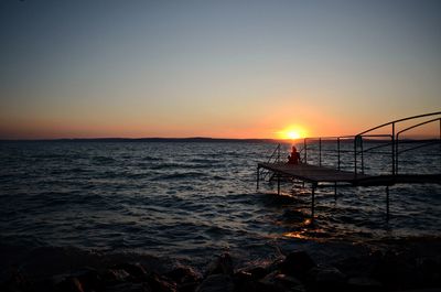 Scenic view of sea against clear sky during sunset