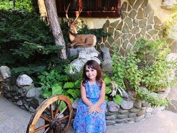 Portrait of woman standing against plants