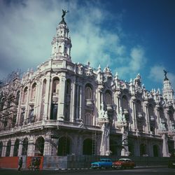 Low angle view of building against cloudy sky