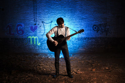 Full length of man playing guitar