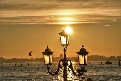 Silhouette people at beach during sunset