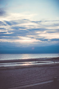 Scenic view of beach against sky during sunset