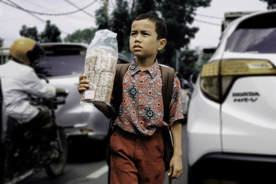 Full length of boy standing in car