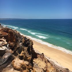 Scenic view of sea against clear blue sky