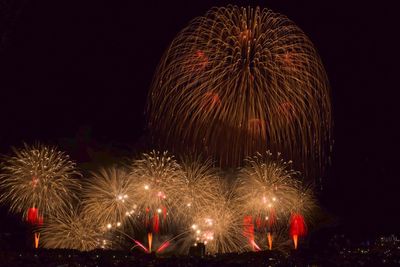 Low angle view of firework display at night