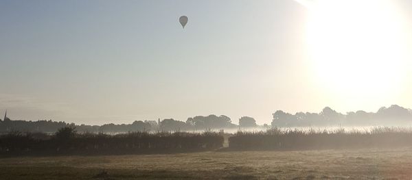 Scenic view of field against sky during foggy weather