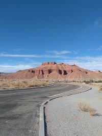 Scenic view of desert against clear blue sky