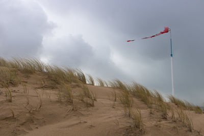 Dune and windsock with rainy and windy weather