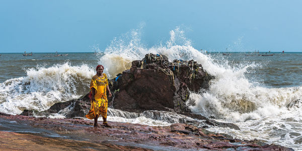 Water splashing in sea against clear sky