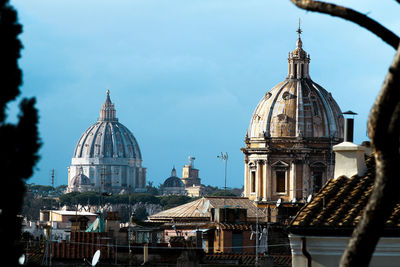 Panorama of rome, domes and roofs. on the left the dome of st. peter's basilica.