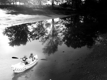 People sitting on boat in lake
