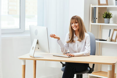 Young woman using laptop at office