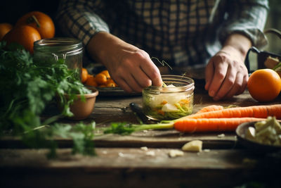 Midsection of man preparing food on table