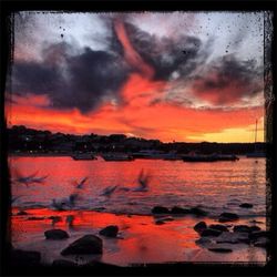 Scenic view of dramatic sky over sea during sunset