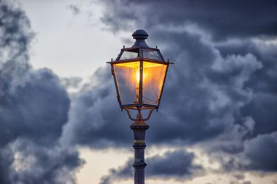 Low angle view of illuminated street light against sky