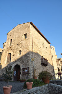 Low angle view of historic building against clear blue sky