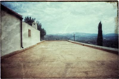 Surface level of empty road along buildings