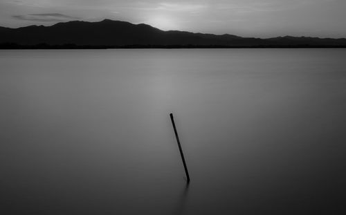 Scenic view of lake against sky at dusk