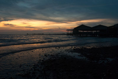 Silhouette of pier at sunset