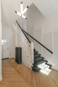 Interior of spacious corridor with staircase on contemporary house designed in minimal style