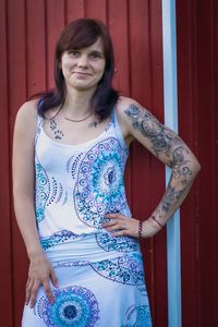 Portrait of woman standing against blue wall