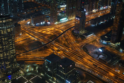 High angle view of city lit up at night