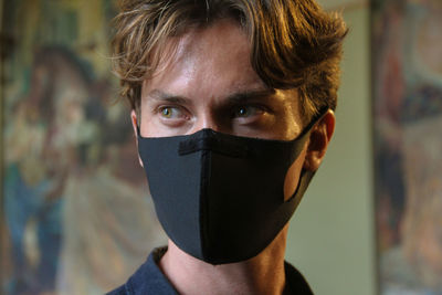 Close-up of man wearing mask looking away