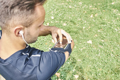 Sportsman looking at his smart phone