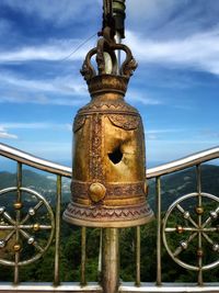 Close-up of metal railing against sky