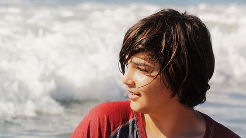 Close-up of boy looking away at beach