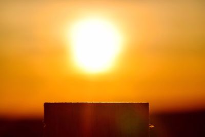 Sun shining over sea during sunset