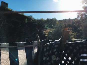 Clothes drying on railing against sky