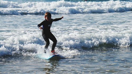 Girl surfing on sea